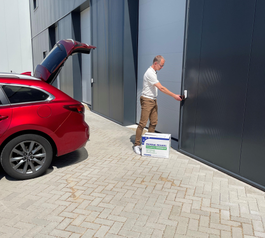 Afbeelding van directeur Lauwrens de Jong die via de selfstorage ingang de deur openmaakt.